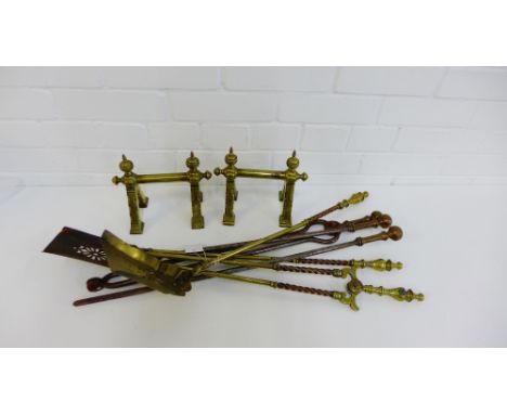 A pair of brass fire dogs, together with brass and iron fireside tools (a lot) 