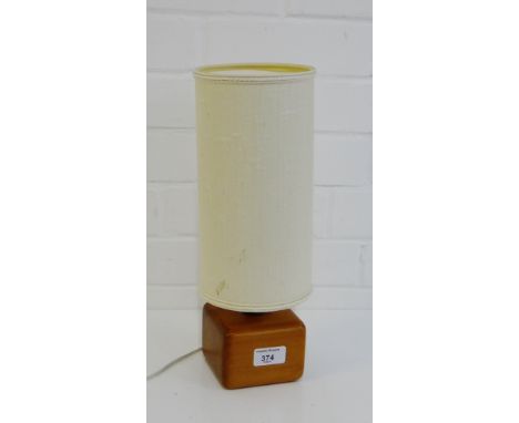 A contemporary wooden cube lamp base and shade