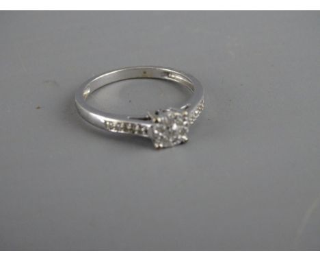 Nine carat white gold ring with diamond set shoulders and cluster setting