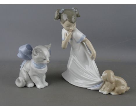 Nao porcelain figurine of a young girl with puppy and one other of a kitten in a large blue bow