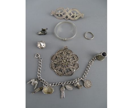 Silver charm bracelet, a filigree pendant, a child's silver bangle etc