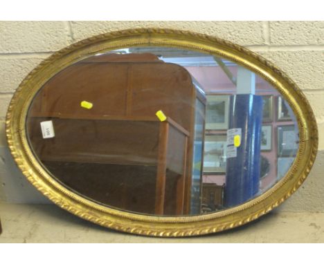 Gilt framed and beaded oval mirror.