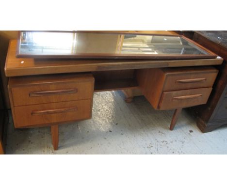 1970s teak 'G' plan mirror backed kneehole dressing table. CONDITION REPORT: Large water stain and other stain on top of tabl