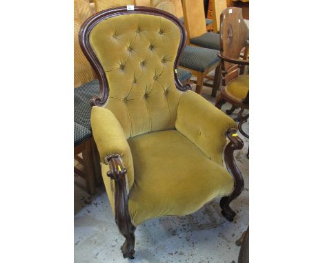 Victorian mahogany button back fireside armchair on cabriole legs and casters.