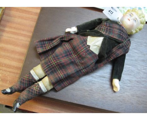 Early 20th Century ceramic doll in tartan outfit.