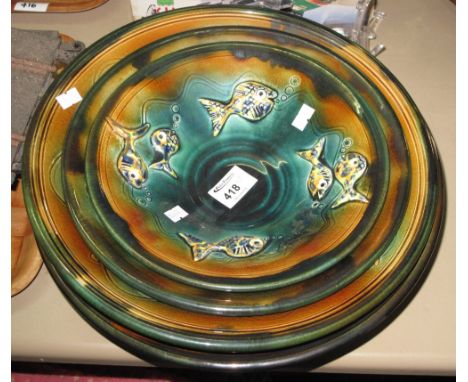 Set of four Studio Art Pottery unique hand made ceramic bowls by Andrew Mason, decorated with relief stylised fish. (4)