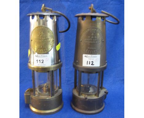 Two Protector Lamp and Lighting Company Ltd. brass miners safety lamps. (2)
