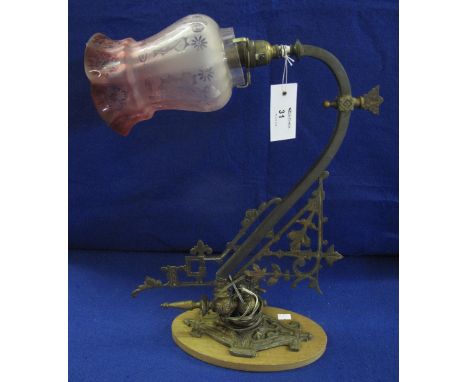 Brass wall light fitting with pierced foliate mounts and etched glass shade, converted to electricity from a gas fitting.