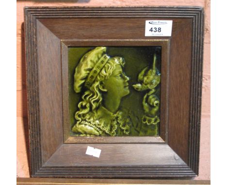 Framed ceramic tile, young girl with bird. CONDITION REPORT: Crazing to tile but no obvious damage.