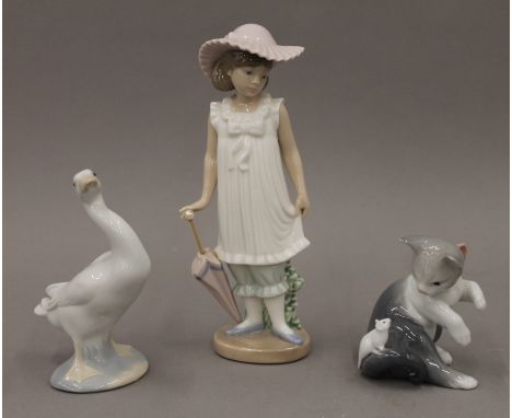 Two Lladro porcelain animals and a Nao porcelain figurine.