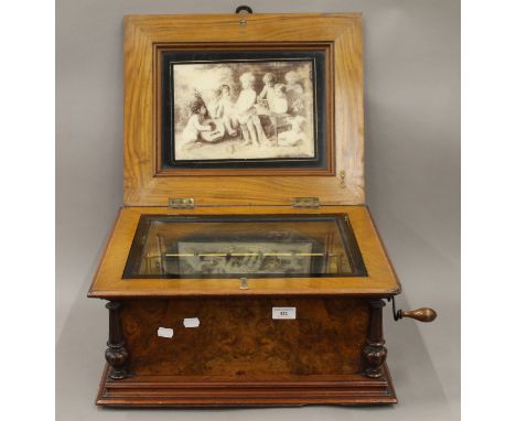 A 19th century inlaid walnut cased polyphon musical box, together with a small quantity of discs. 50 cm wide.