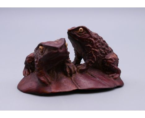 A Japanese wood netsuke of two frogs. 5.5 cm wide.
