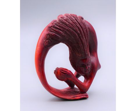 A mermaid form netsuke. 4.25 cm high.