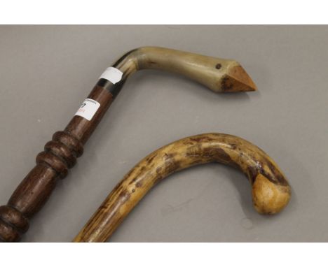 A horn handled walking stick and another. The former 91 cm long.