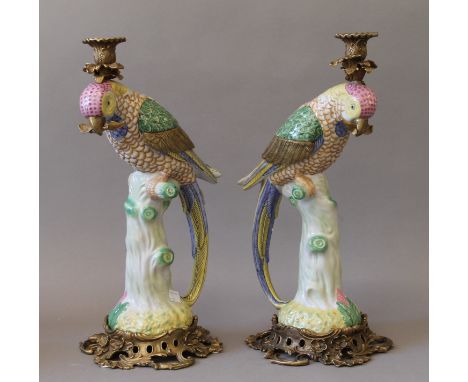 A pair of gilt metal mounted porcelain candlestick formed as parrots. 40.5 cm high.