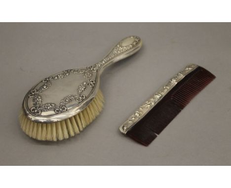 A boxed silver brush and comb set. The box 28 cm wide.