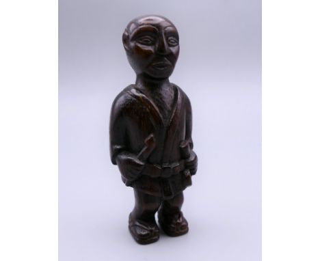 A Japanese netsuke carved as a man. 7 cm high.