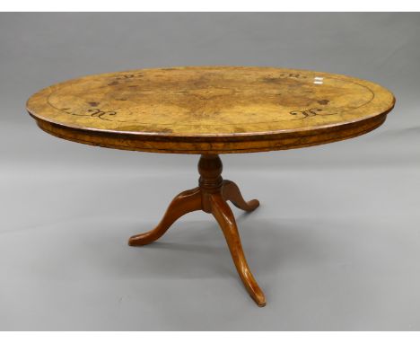 A Victorian inlaid walnut loo table, mounted on associated tripod base. 106 cm long.