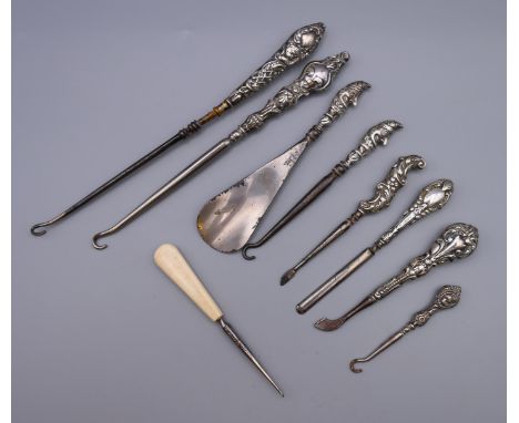 A quantity of silver handled button hooks, etc.