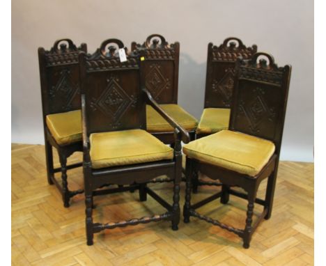 A set of five oak Carolean-style chairs, comprising one open arm of wainscot type and four plank top single chairs, lozenge c