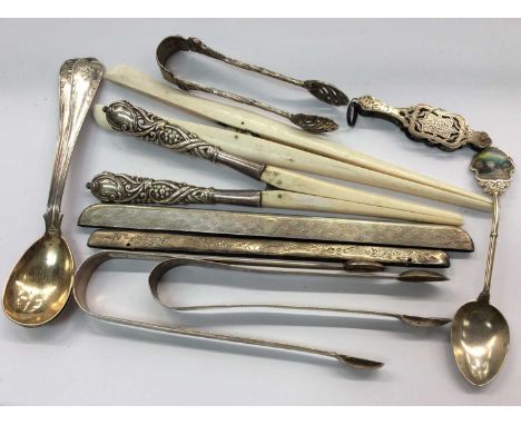 Pair silver sugar tongs, silver souvenir spoon, pair silver handled glove stretchers, two silver comb mounts and other items