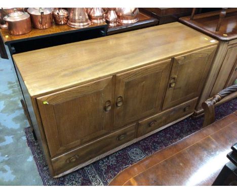 Ercol elm sideboard with three doors and drawers 129 cm wide, 76 cm high, 43 cm deep