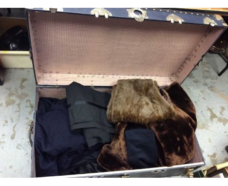 Large vintage travelling trunk containing gentlemen’s suits, jackets, fur stole and faux fur coat 