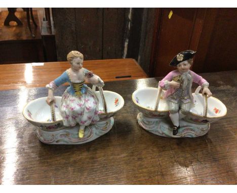 Pair of 19th century Meissen porcelain baskets with figure mounts, blue crossed swords and impressed marks to baseCondition r
