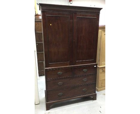 Georgian mahogany wardrobe/linen press with two panelled doors and two short and two long graduated drawers on bracket feet 1