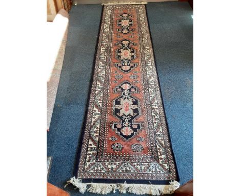 Eastern runner with geometric decoration on blue and cream ground, 292cm x 76cmCondition report: Modern rug, very good and cl