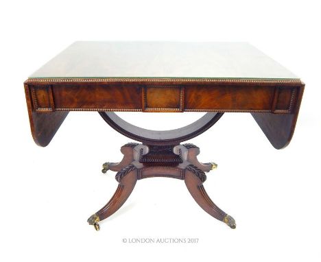 A Georgian rosewood sofa table; with bowed support fitting to is base; 143cm wide (fully extended); 72cm high; 65cm deep.