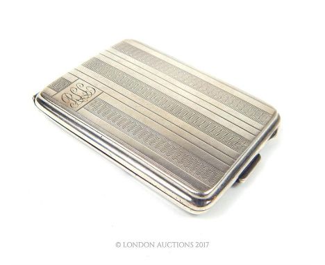 An Art Deco silver vesta case with decorative vertical rows of engine turned engraving to front and reverse of case and monog