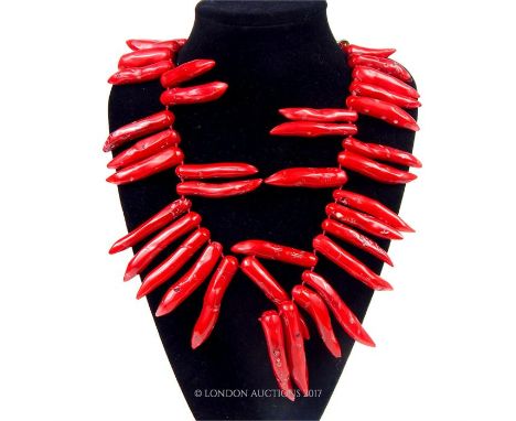 A very large, chunky, blood- red coral necklace with silver clasp (string strand broken) composed of fourty- five tooth- shap
