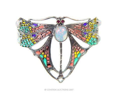 A silver plique a jour, Art Nouveau style cuff bangle; featuring a butterfly and studded with opals.