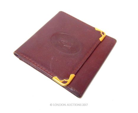 A Cartier Paris lady's leather purse; 8cm x 8cm.