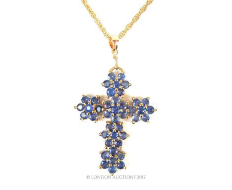 14 ct yellow gold blue topaz cross pendant and 9 ct yellow gold chain, the cross composed of six, claw-set blue topaz flower 