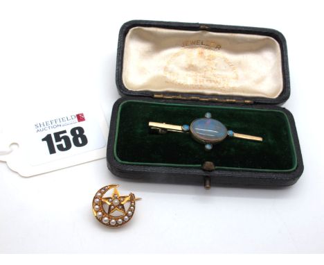 A Single Stone Bar Brooch, oval collet set with circular cabochon highlights, stamped "375" (4.5cm long), contained in a vint