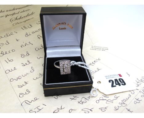 An Art Deco Stye Diamond Set Rectangular Panel Ring, millegrain set throughout with graduated old brilliant cut stones, betwe