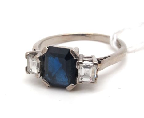 An Art Deco Style Sapphire and Diamond Three Stone Ring, rectangular set to the centre between square cut shoulders, stamped 