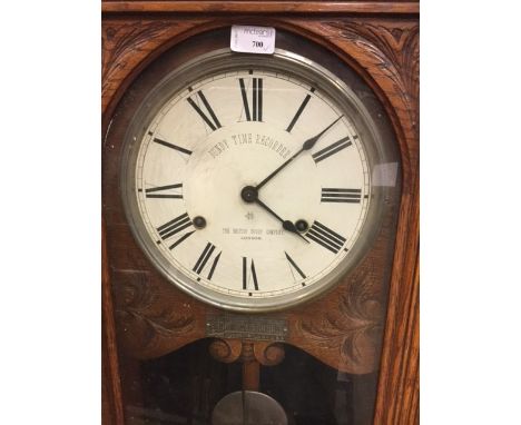 VICTORIAN OAK BUNDY TIME RECORDER the lofty stepped architectural pediment above a glazed case, the dial with Roman numerals 