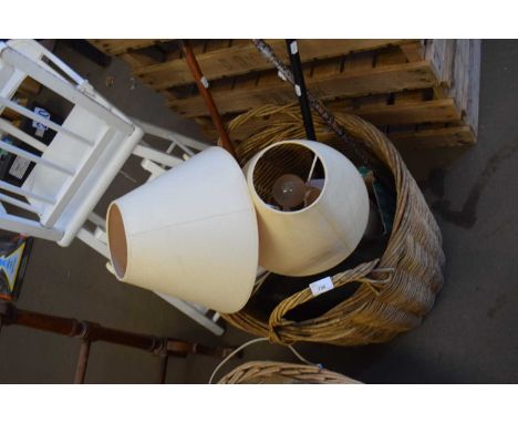 Basket containing various walking sticks and lamp