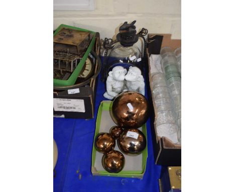 A quantity of bronze glazed ceramic balls together with a model of a monkey and a hanging candle lantern
