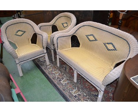 A three piece Lloyd Loom style conservatory suite comprising two tub chairs and two a seater sofa.