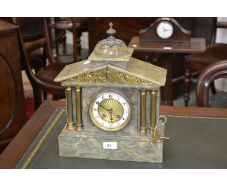 A  variegated green marble mantel clock, B.H.A Britannia movement, domed top surmounted by brass finial to the architectural 