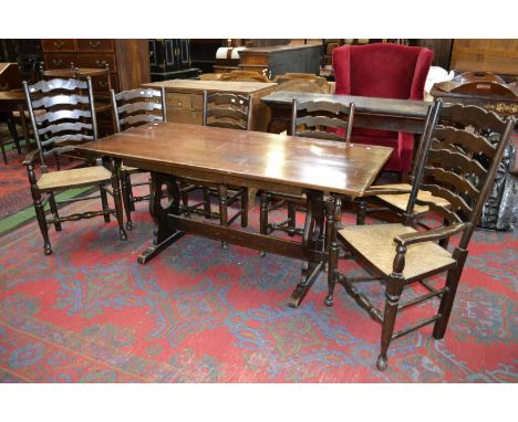 An oak refectory style table, rounded rectangular top, lyre shaped supports; six rush seated ladder back dining chairs; two c
