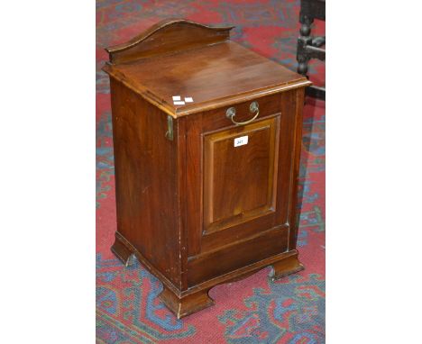 A mahogany purdonium, shaped gallery, moulded top, fielded panel fall front opening to metal liner, bracket feet, ceramic cas
