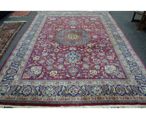 An antique Persian mashad carpet, 340cm x 252cm