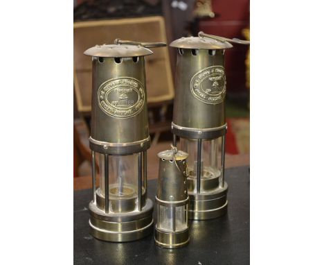A pair of mining lamps, E.Thomas & Williams Ltd. Cumbrian dated 1987 and a miniature mining lamp.