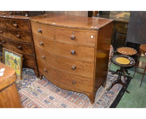 A Victorian mahogany bow front chest, oversailing top, two short cockbeaded drawers over three graduated long, button handles