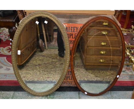 A mahogany oval framed mirror; another oval framed mirror ( 2 )